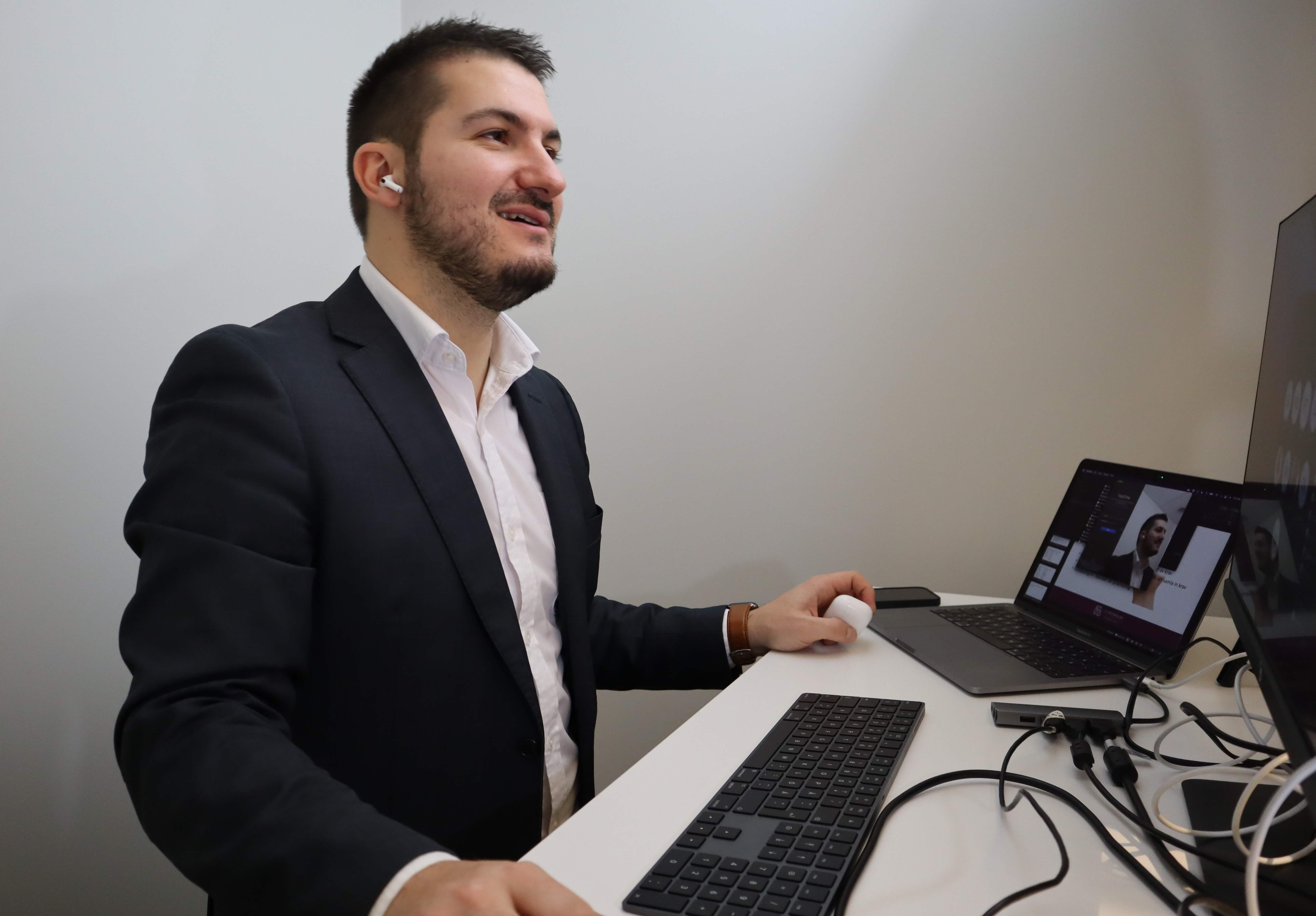 A male SAP expert having a video call at a desk