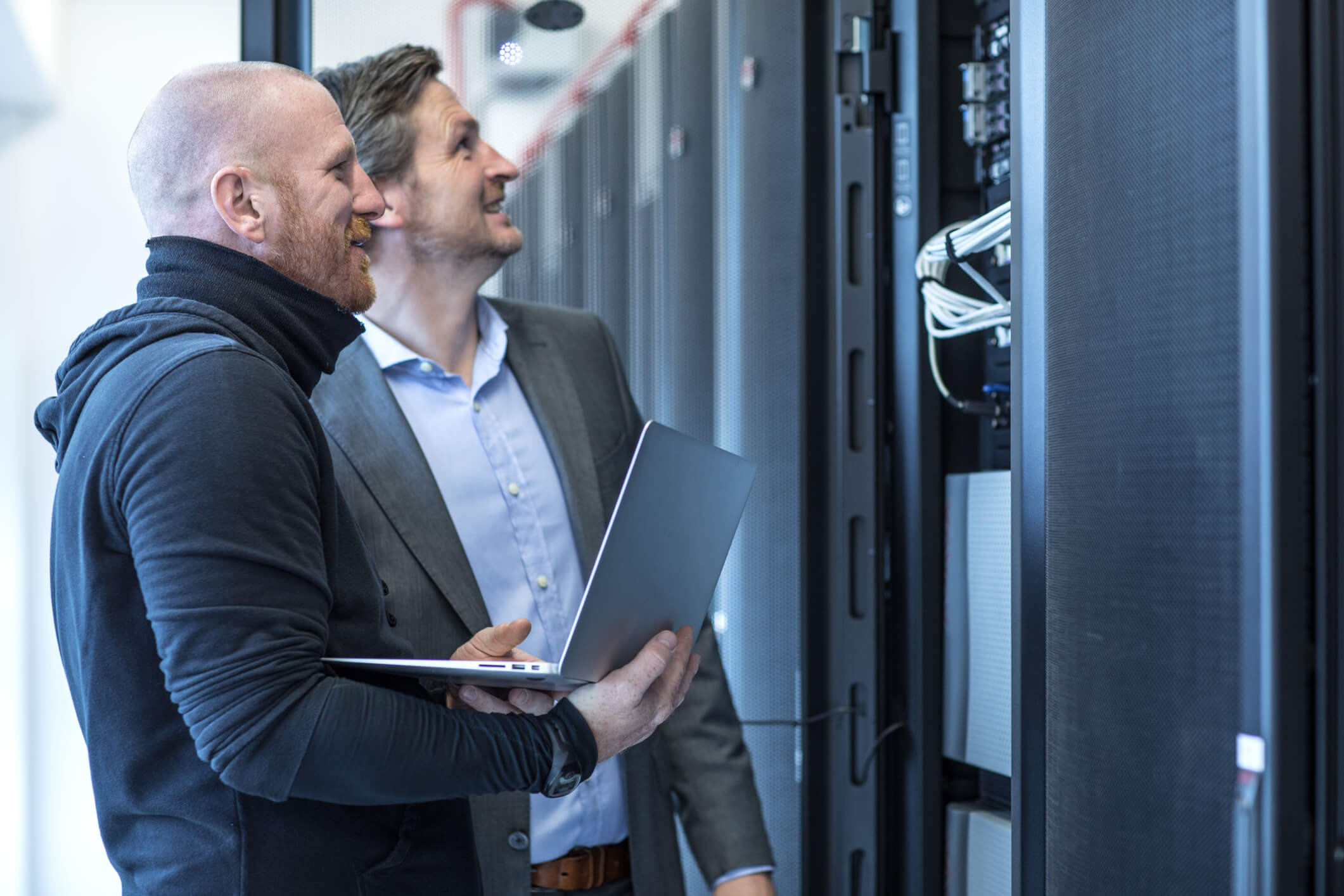 Two people looking at a server rack