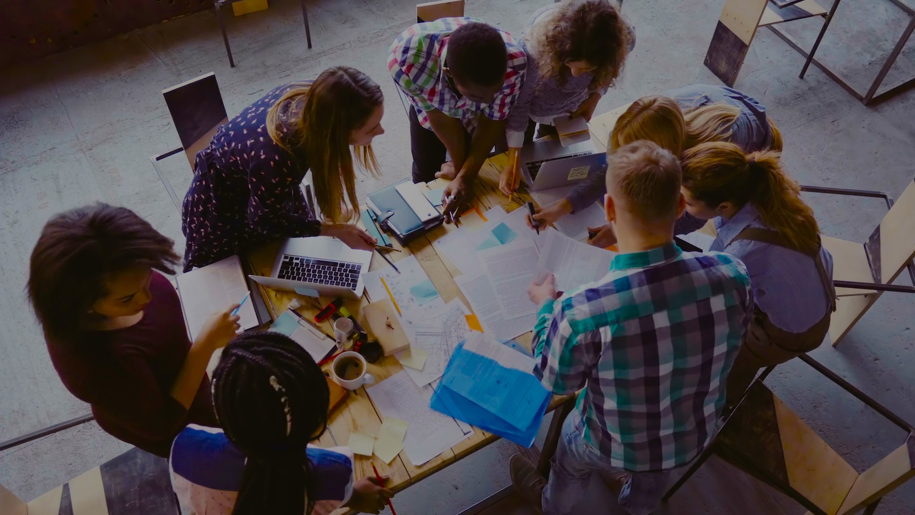 A group of people brainstorming with paper on a table