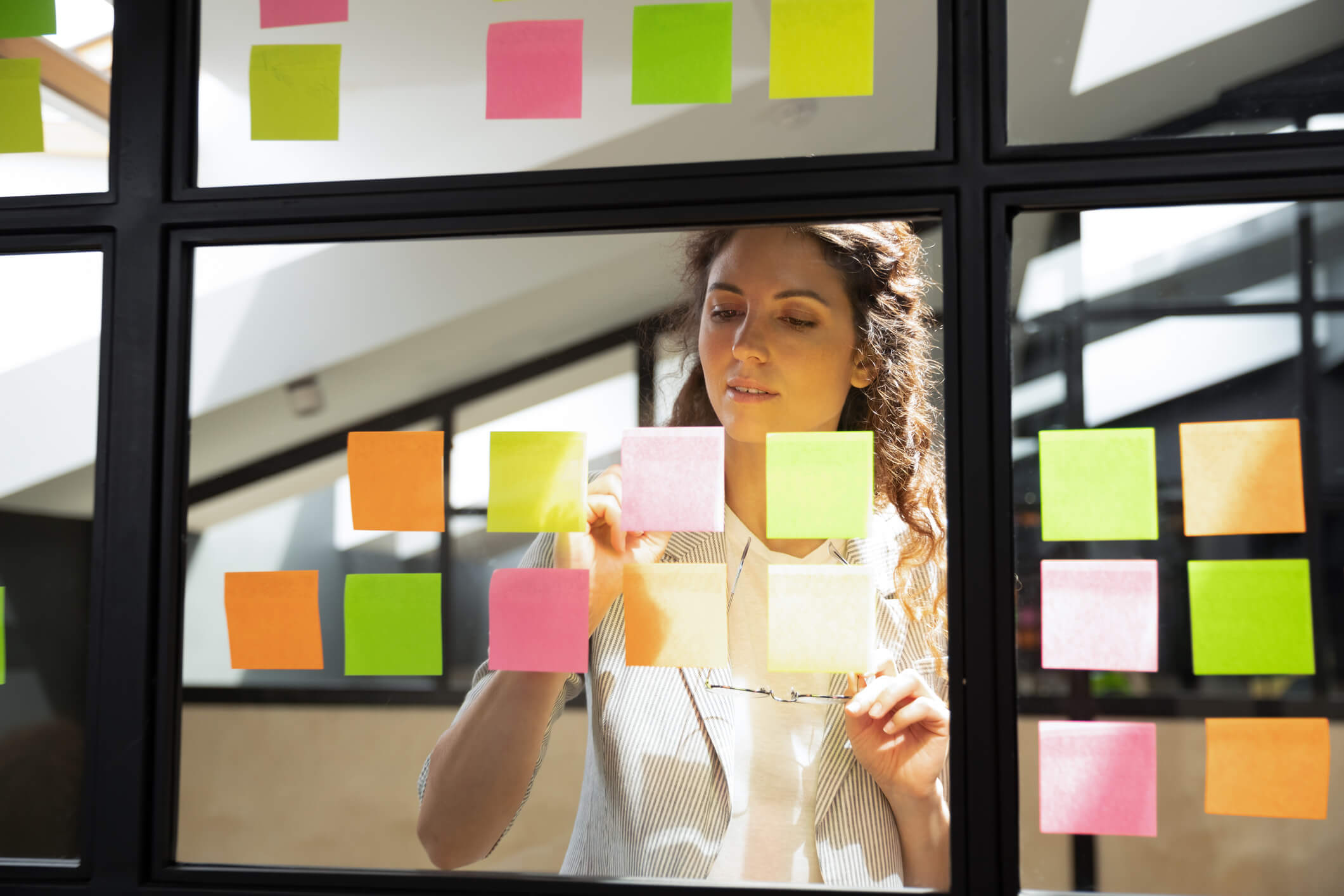 woman writing requirements on stickers