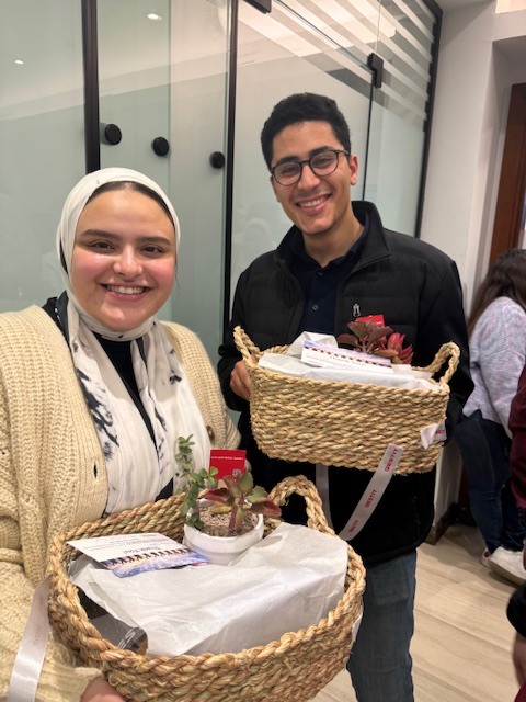 Colleagues from Egypt with their basket from the new offices party 